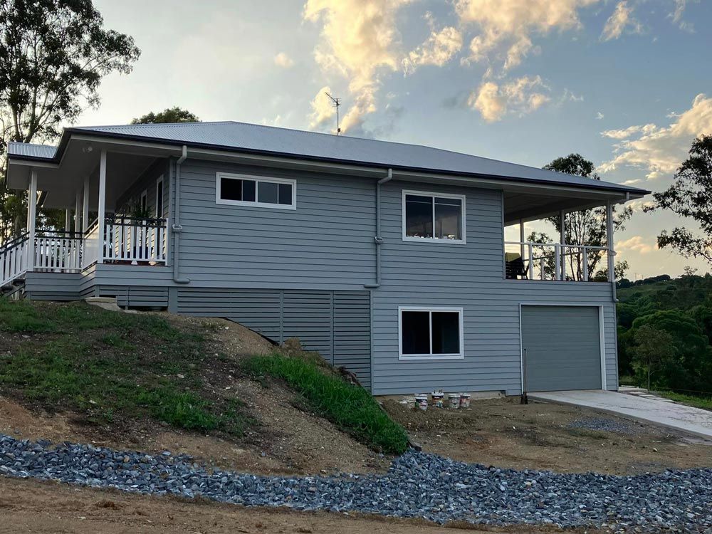 Large Gray House With A Garage And A Porch — Builder In Gympie, QLD