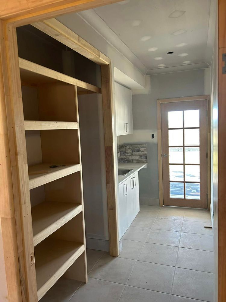 Kitchen Under Construction With Wooden Shelves And A Door — Builder In Gympie, QLD