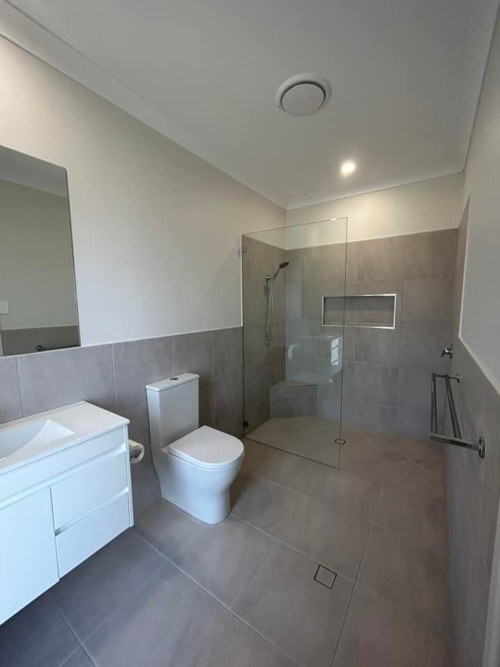 Bathroom With A Toilet, Sink And Walk In Shower — Builder In Gympie, QLD