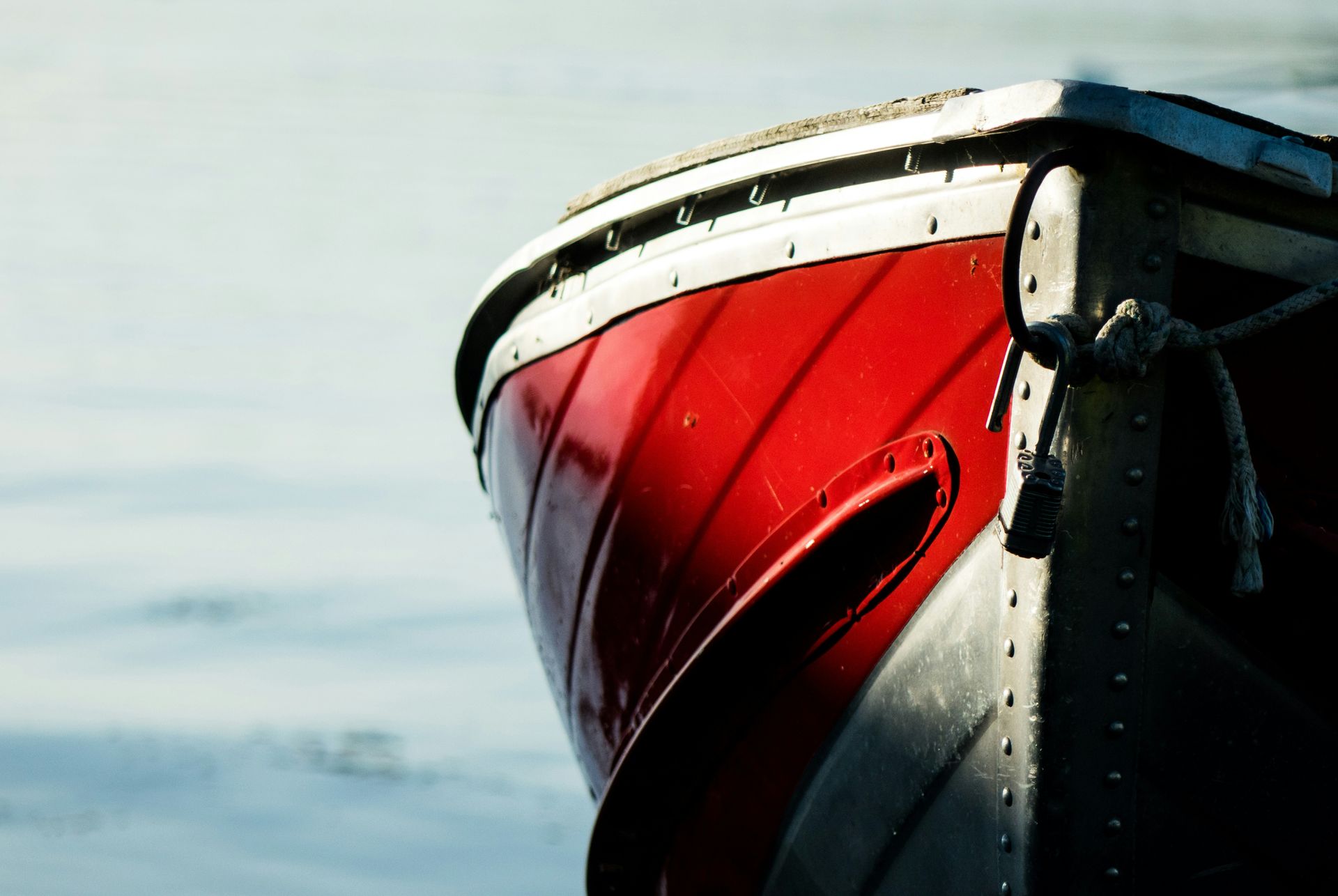 A red and silver boat is in the water