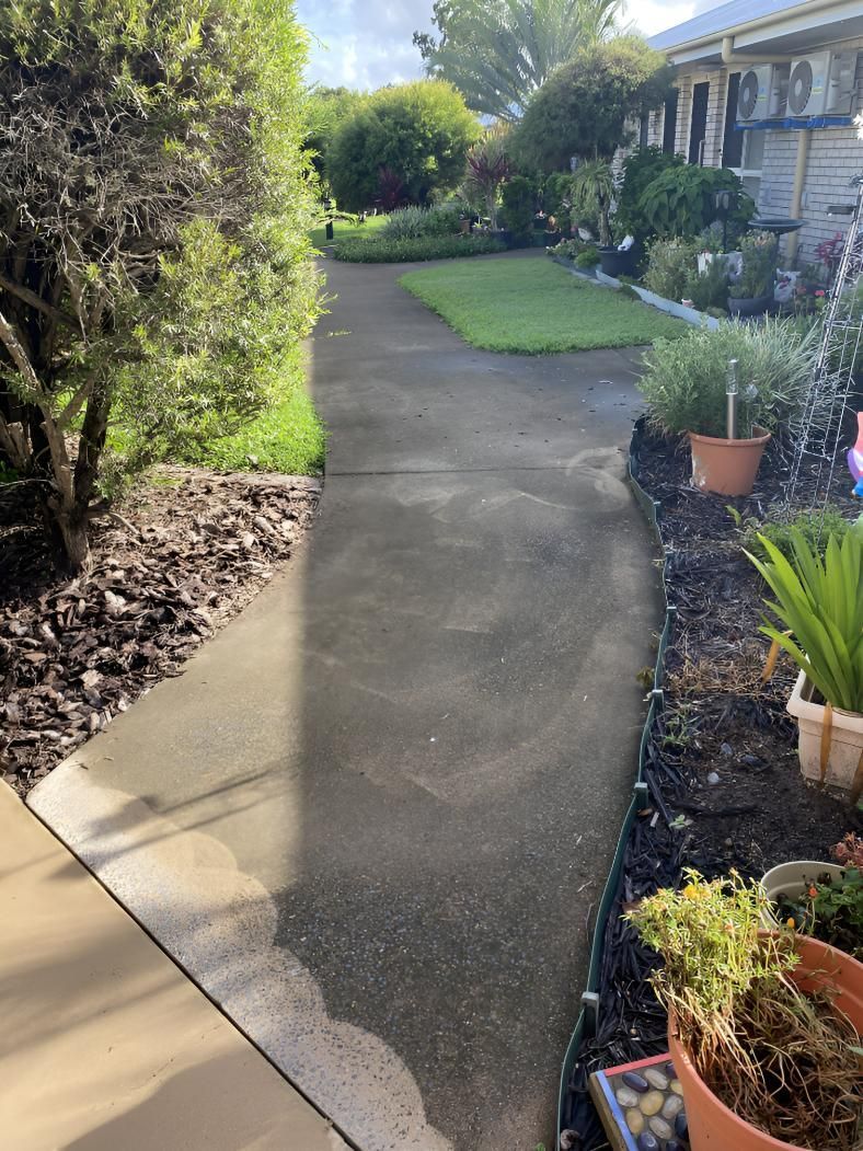 A Shadow of A Person Is Cast on A Sidewalk in A Garden — Hard Surface Cleaners in Gold Coast, QLD