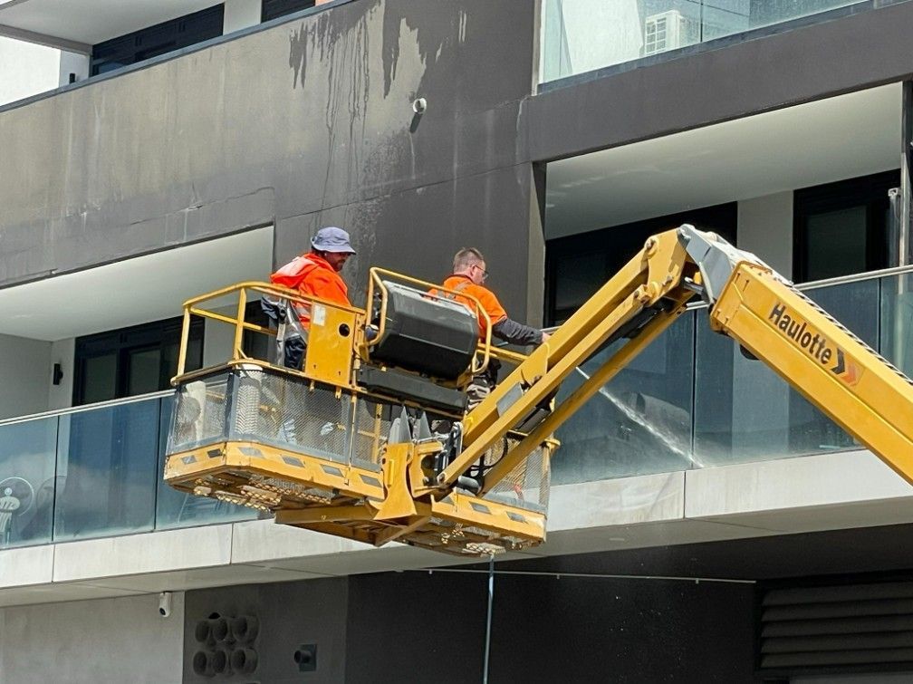 Two Men Are Working on a Balcony of a Building — Hard Surface Cleaners in Gold Coast, QLD
