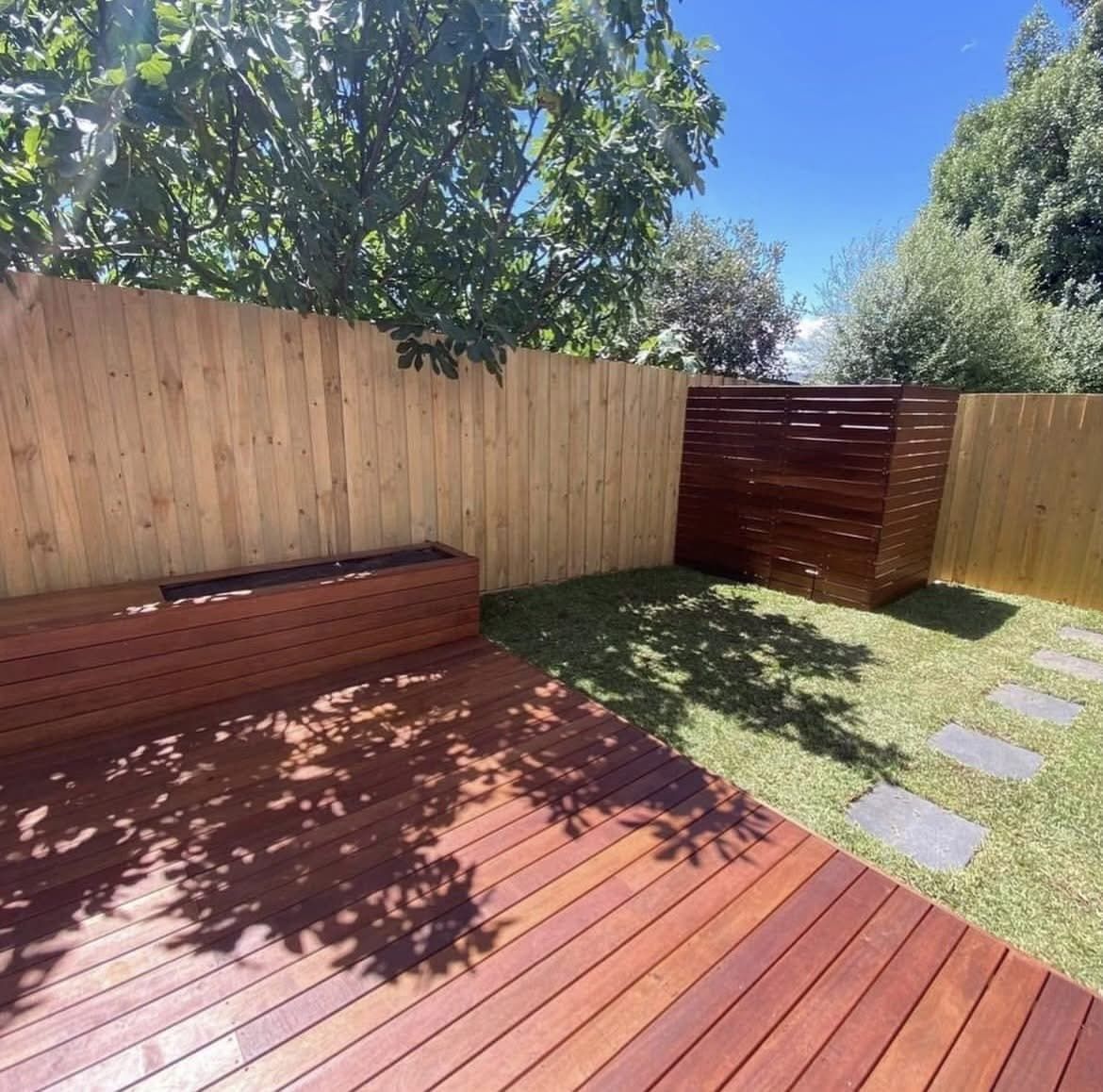 There is a wooden deck in the backyard with a wooden fence. — Hard Surface Cleaners in Clayton, VIC