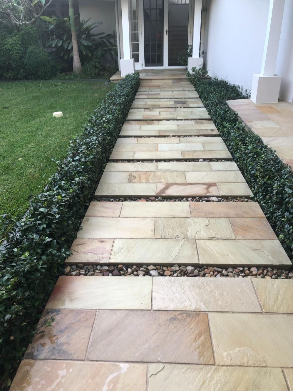 A Stone Walkway Leading to The Front Door of A House — Hard Surface Cleaners in Sydney, NSW