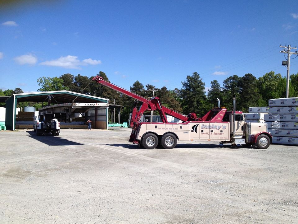 Undecking A Flatbed Trailer With Two Heavies — Insley’s Towing and Recovery — Pine Bluff, AR