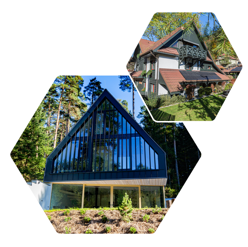 A house with a triangle shaped roof and a lot of windows is surrounded by trees.