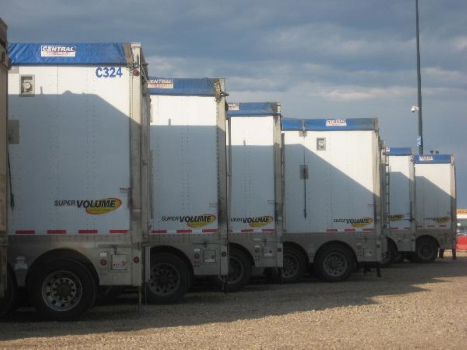 White semi-truck with long trailer parked on a road.