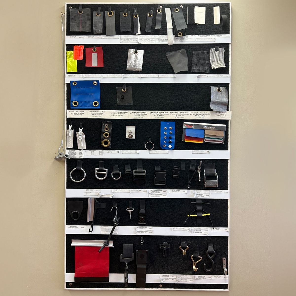 Display board with various black and white fabric and hardware samples.