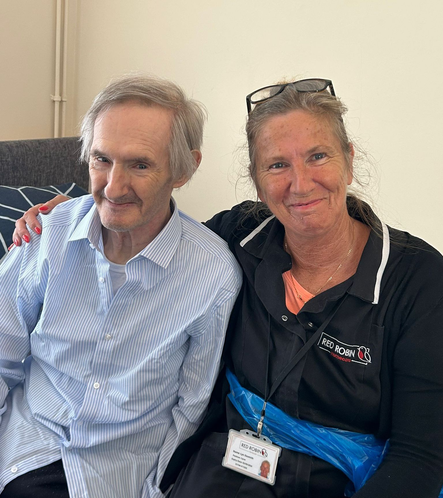 A man and a woman are sitting next to each other on a couch.