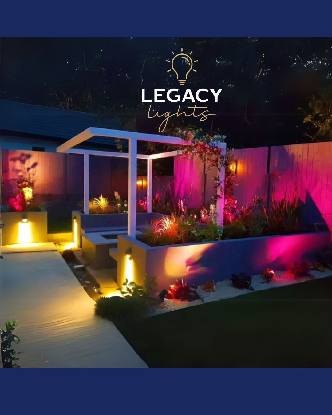 Outdoor garden with Legacy Lights illuminating plants, walls, and structure at night; purples and golds.