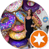 Woman posing by colorful painted stone steps with circular art and orange star logo