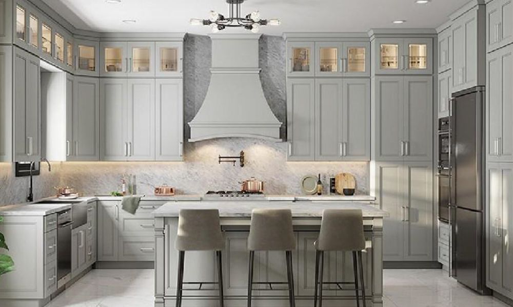 A kitchen with gray cabinets , stainless steel appliances , and a large island.