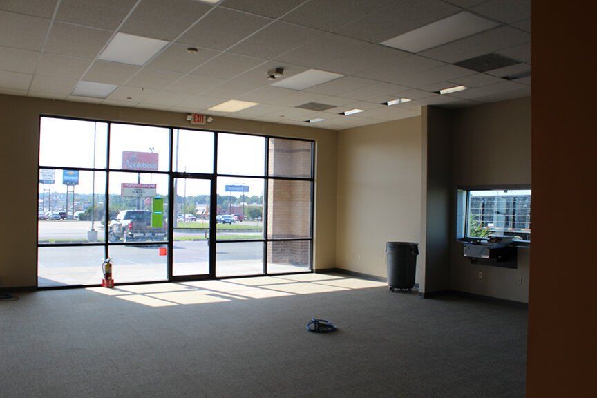 A Bright but Empty Office Interior With a Large Window. Find an Office for Rent in Columbia, MO.