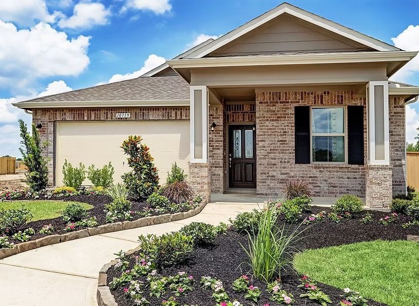 Brick house with a walkway, front porch, and landscaped garden under a cloudy sky.