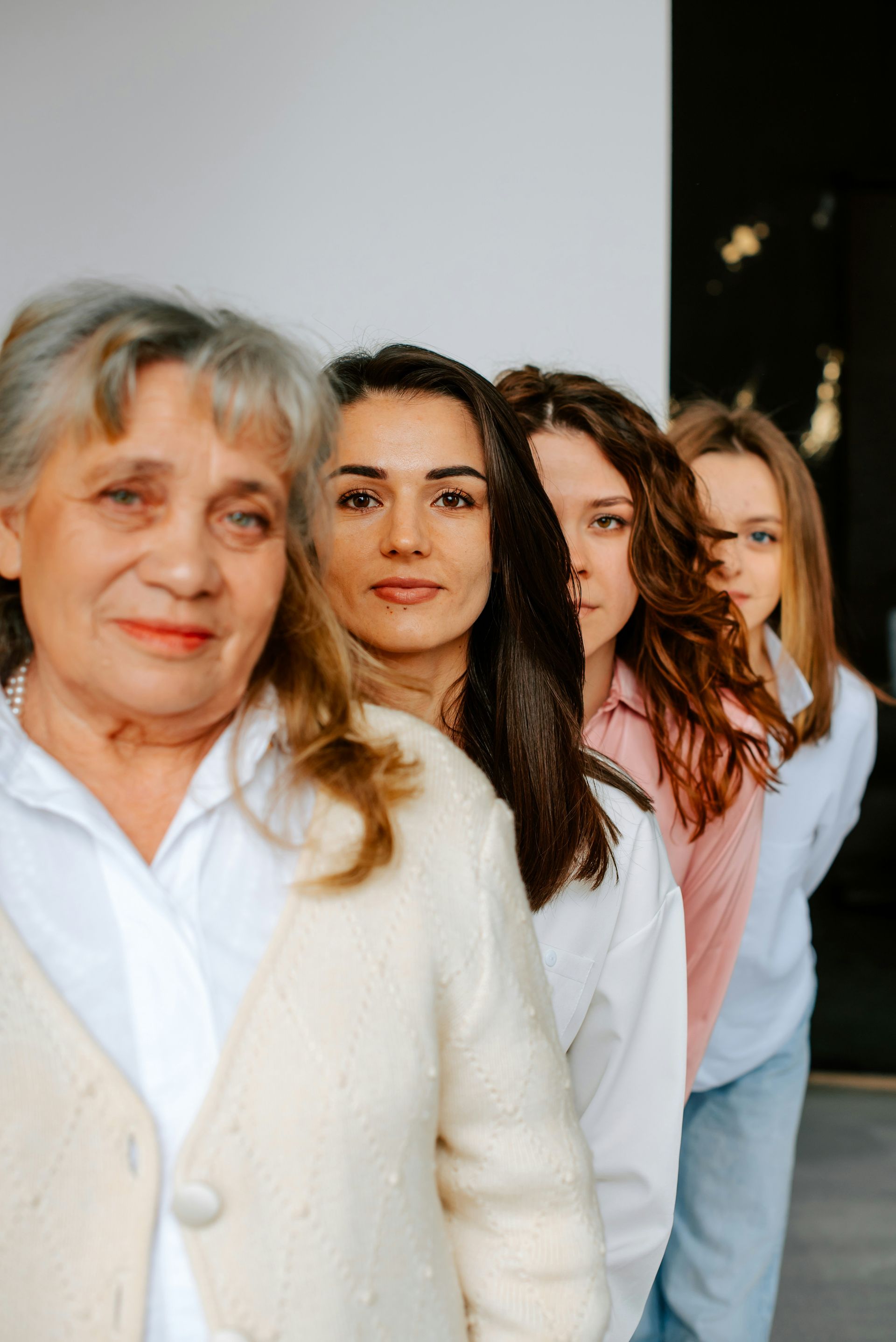 A group of women are standing next to each other in a row.
