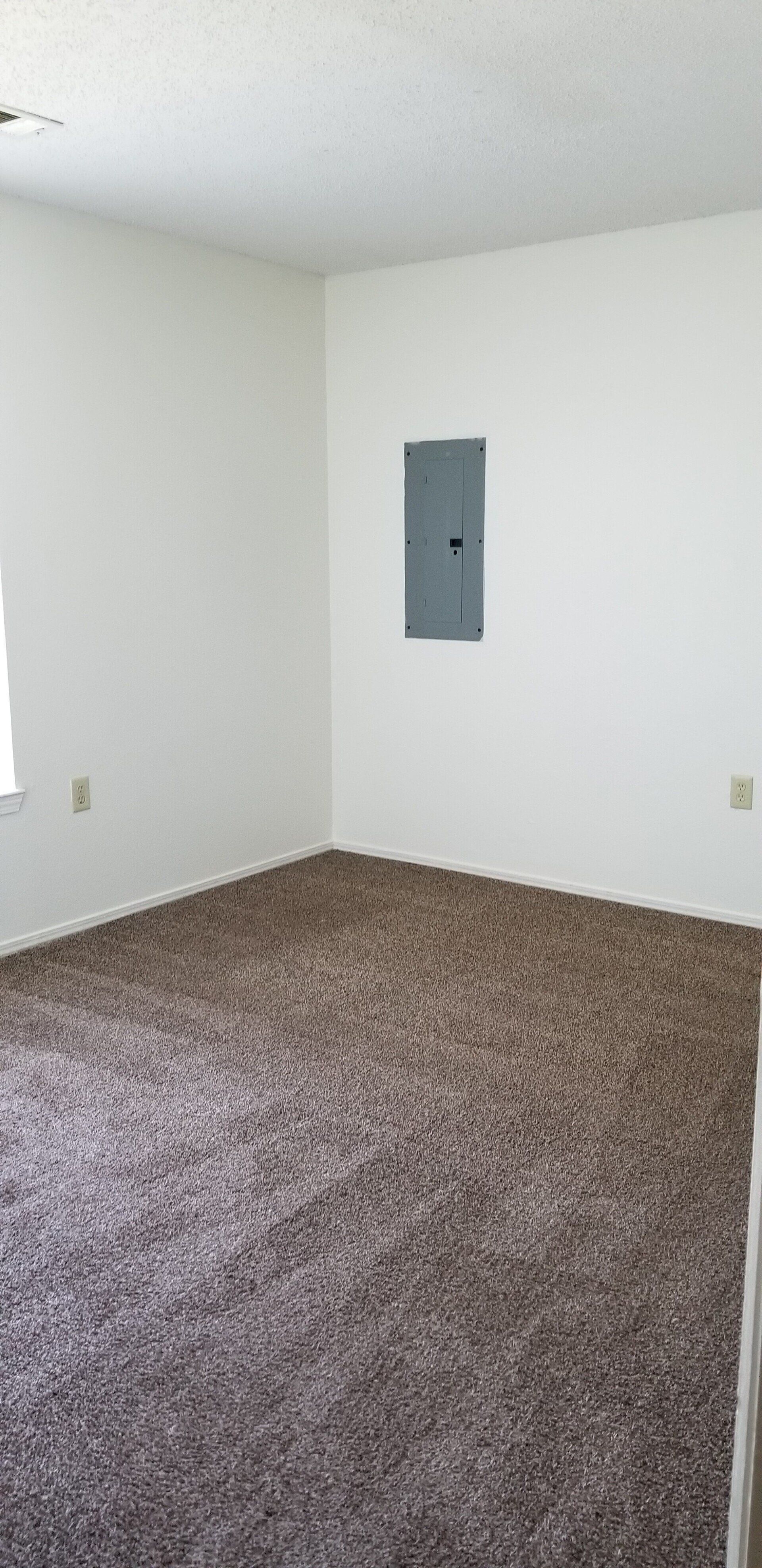 Interior of carpeted room with window