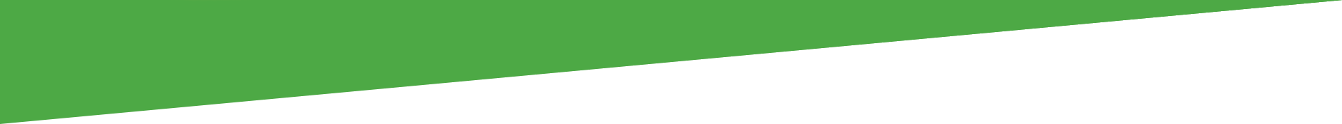 A piece of green paper is being cut in half on a white background.