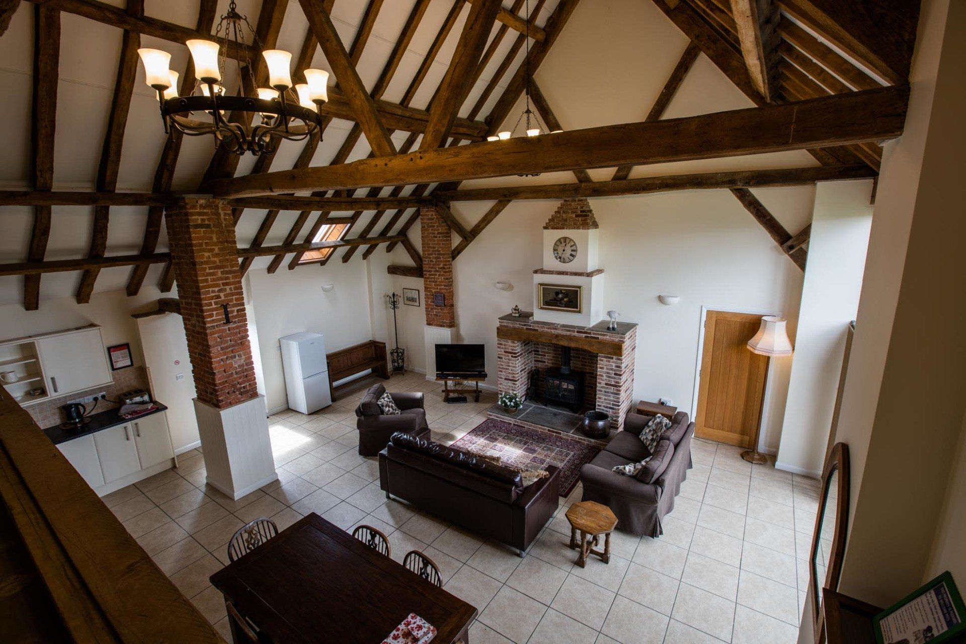 A living room with a fireplace , couch , table and chairs.