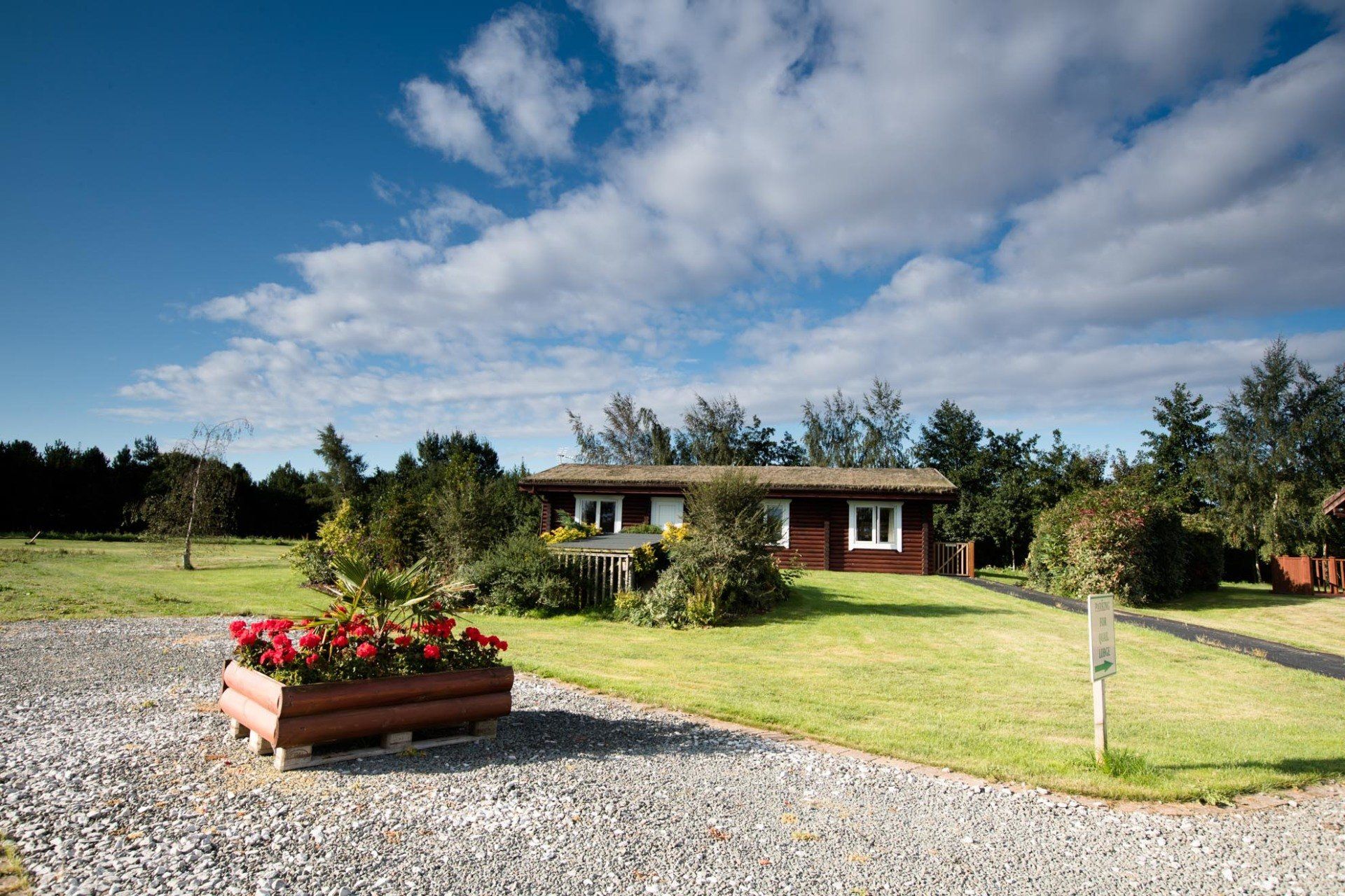 A house with a gravel driveway in front of it