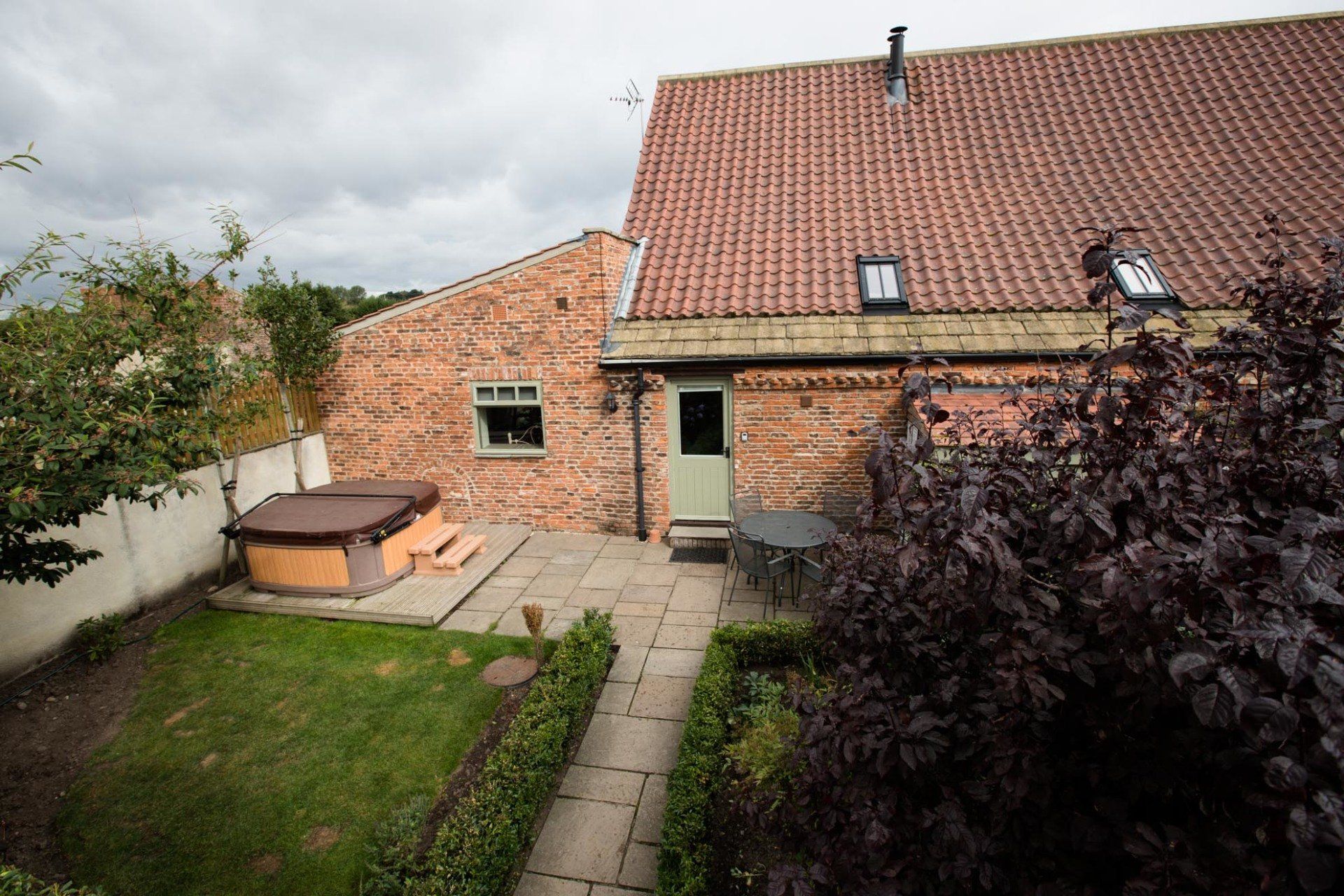 There is a hot tub in the backyard of a house.