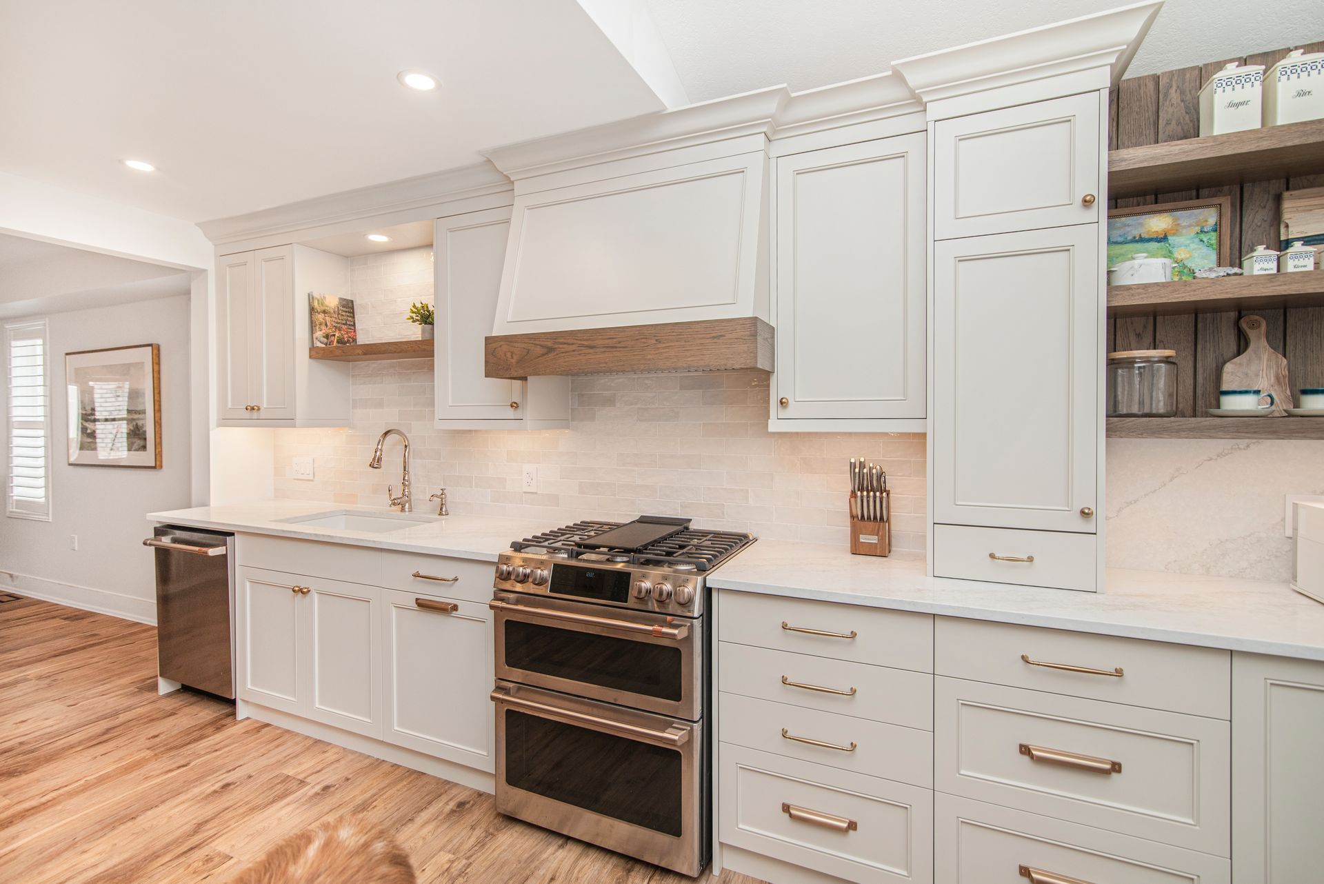 A kitchen with white cabinets and stainless steel appliances.