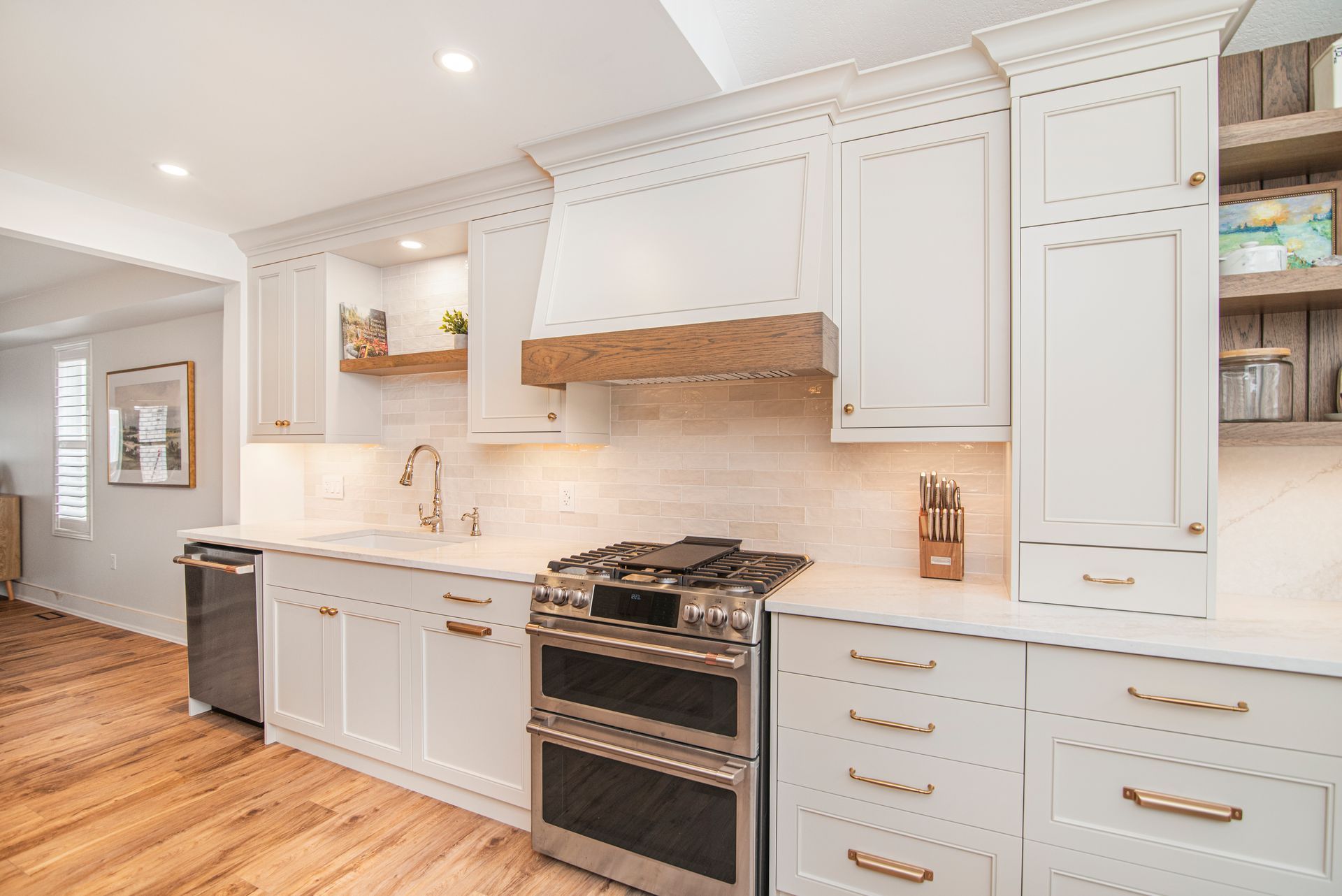 A kitchen with white cabinets and stainless steel appliances.