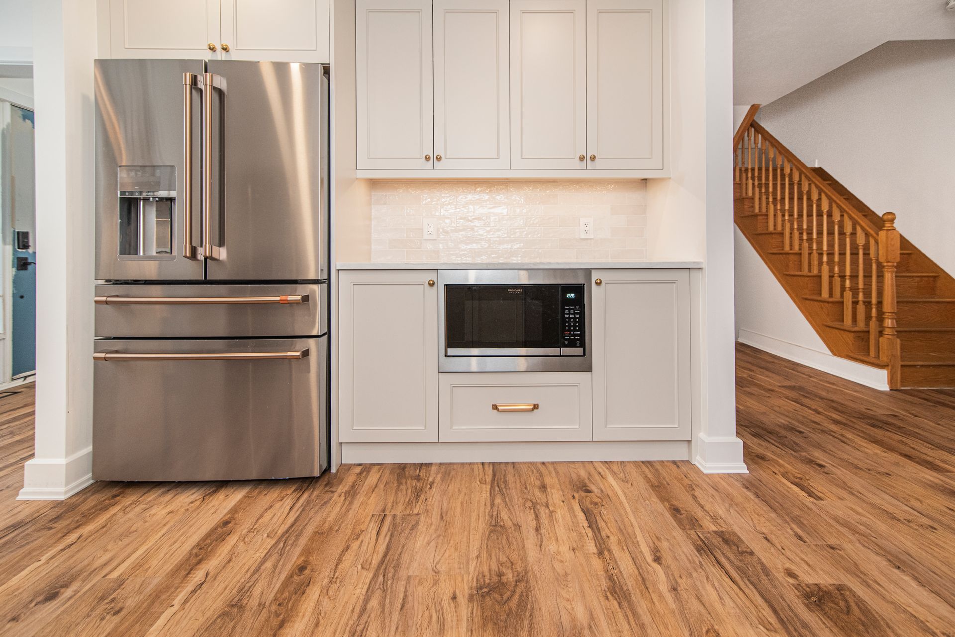 A kitchen with stainless steel appliances and hardwood floors.