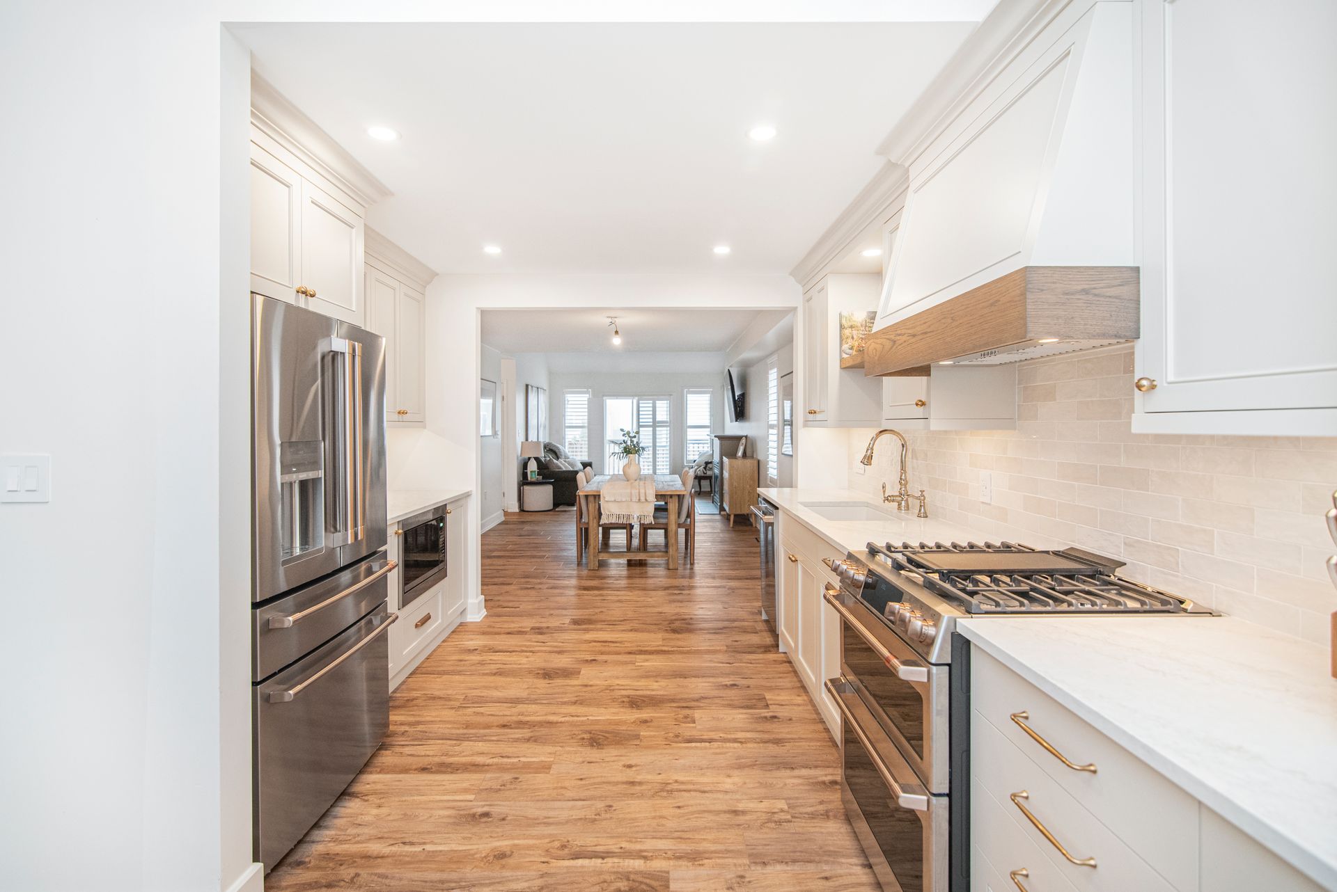 A kitchen with stainless steel appliances and white cabinets