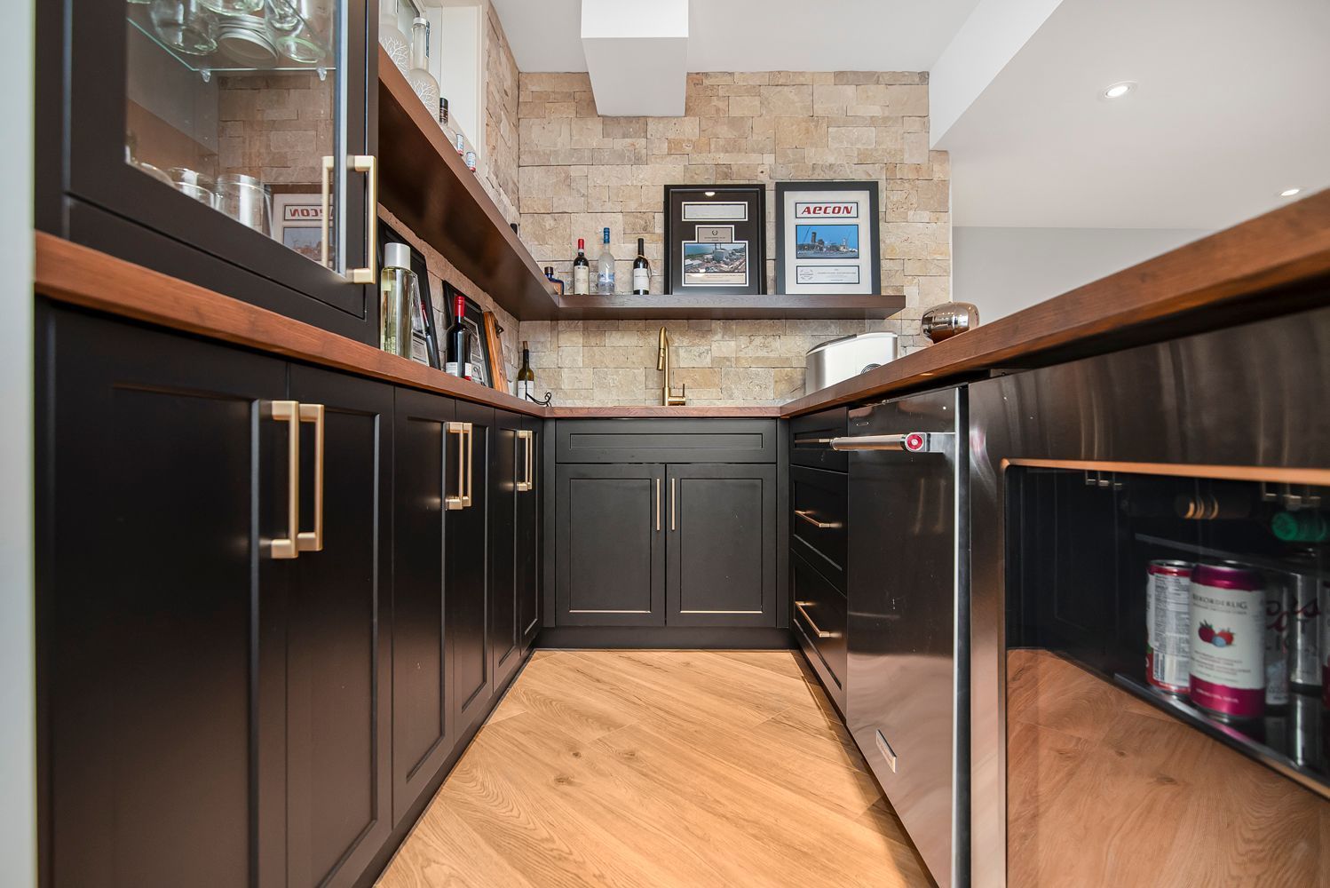 A kitchen with black cabinets and stainless steel appliances.