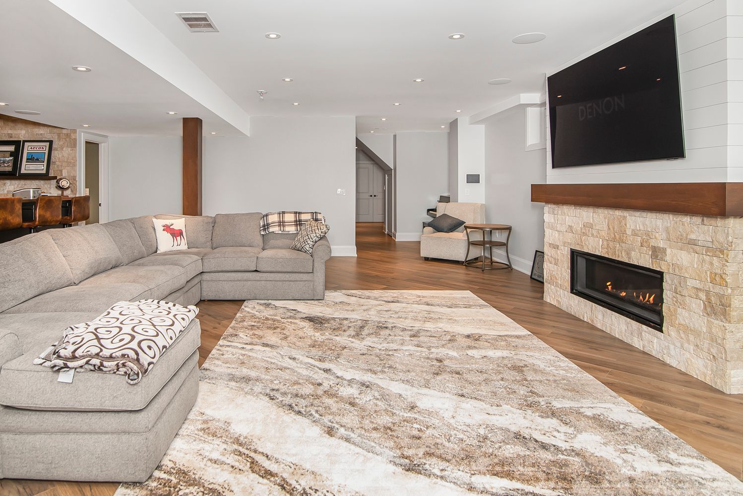 A large living room with a couch , fireplace and television.