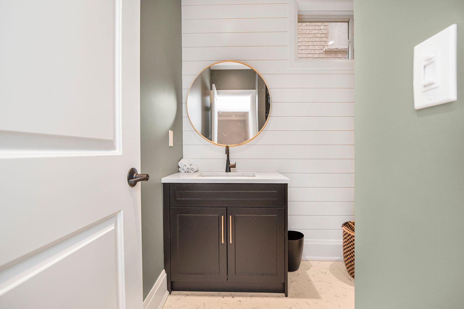 A bathroom with a sink , mirror and toilet.