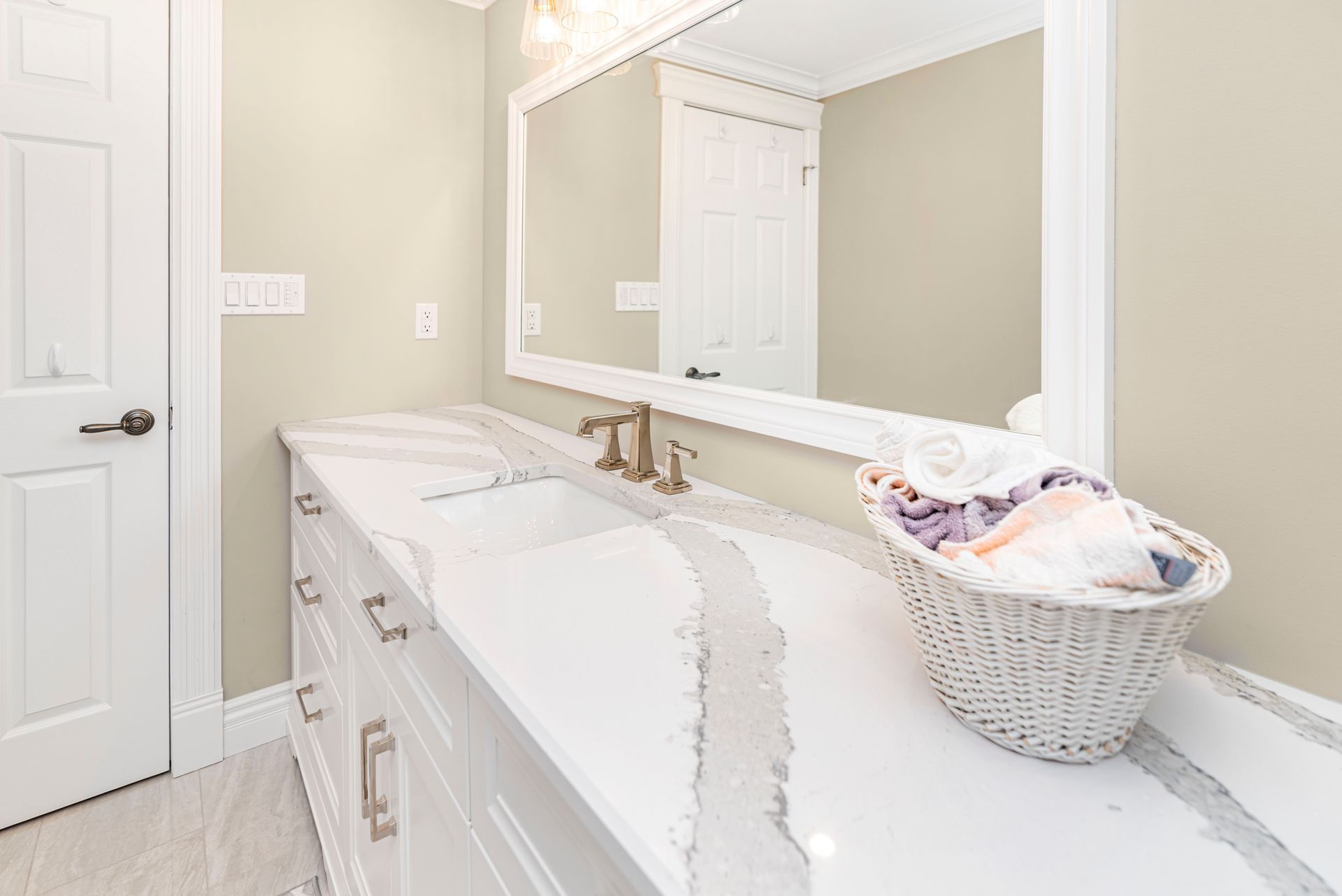 A bathroom with two sinks and a large mirror.