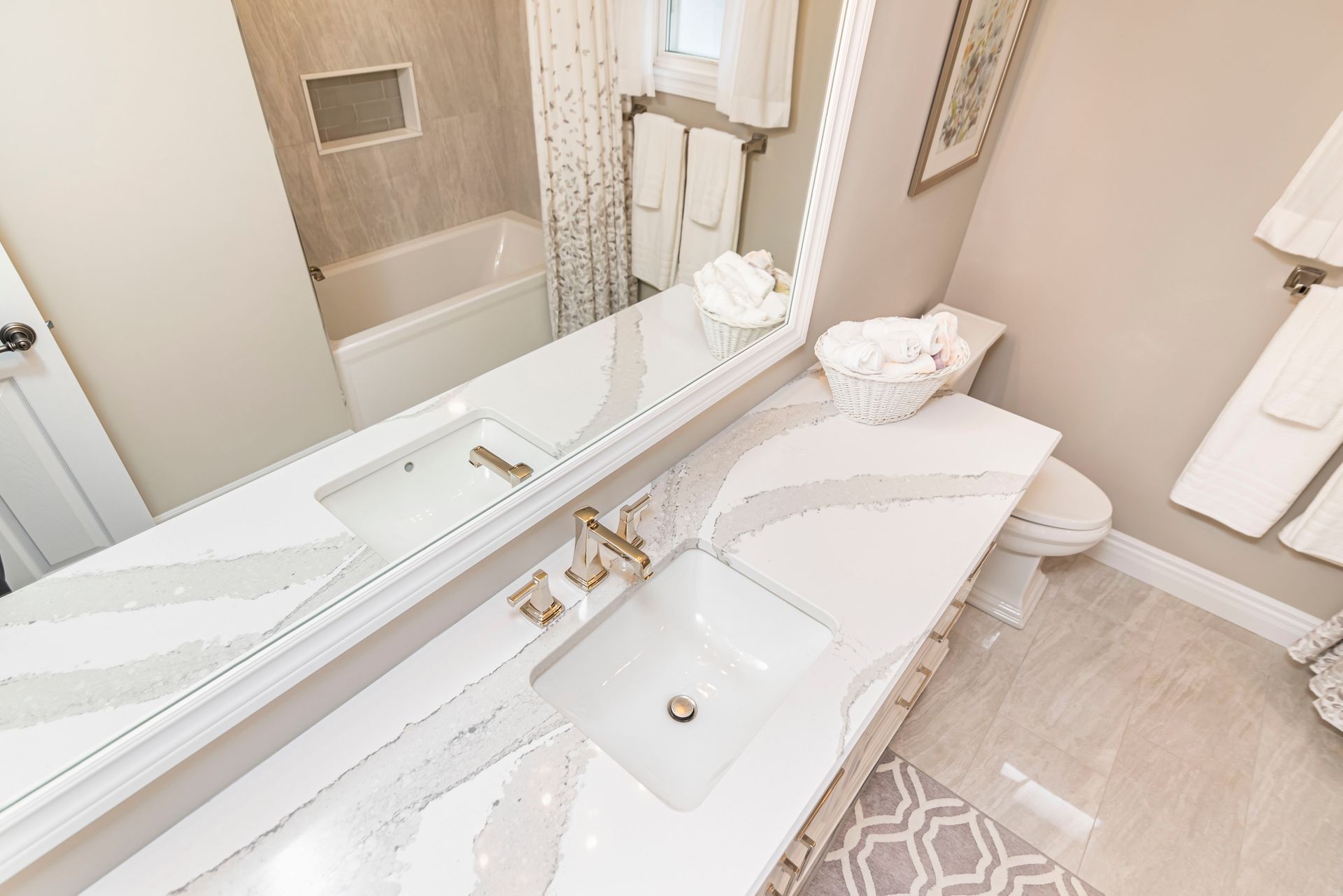 A bathroom with two sinks , a toilet , and a large mirror.