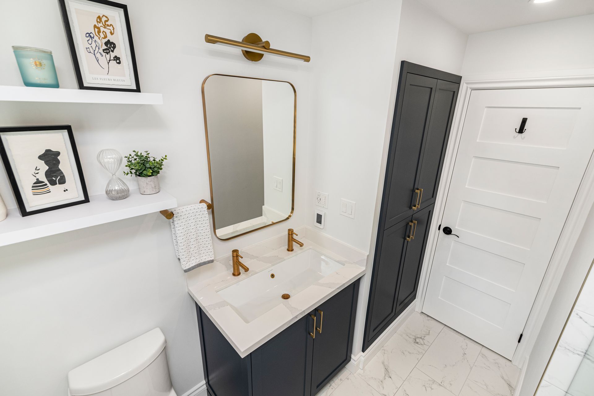 A bathroom with a sink , toilet and mirror.