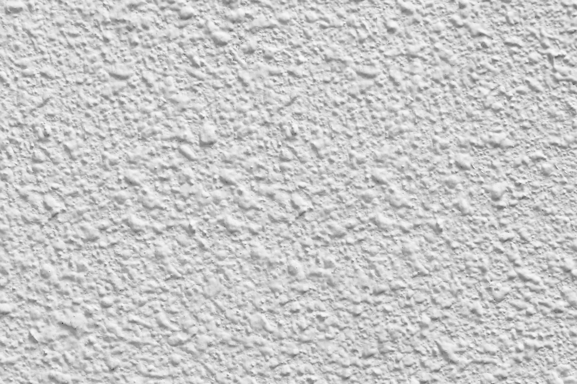A close up of a white wall with a rough texture.