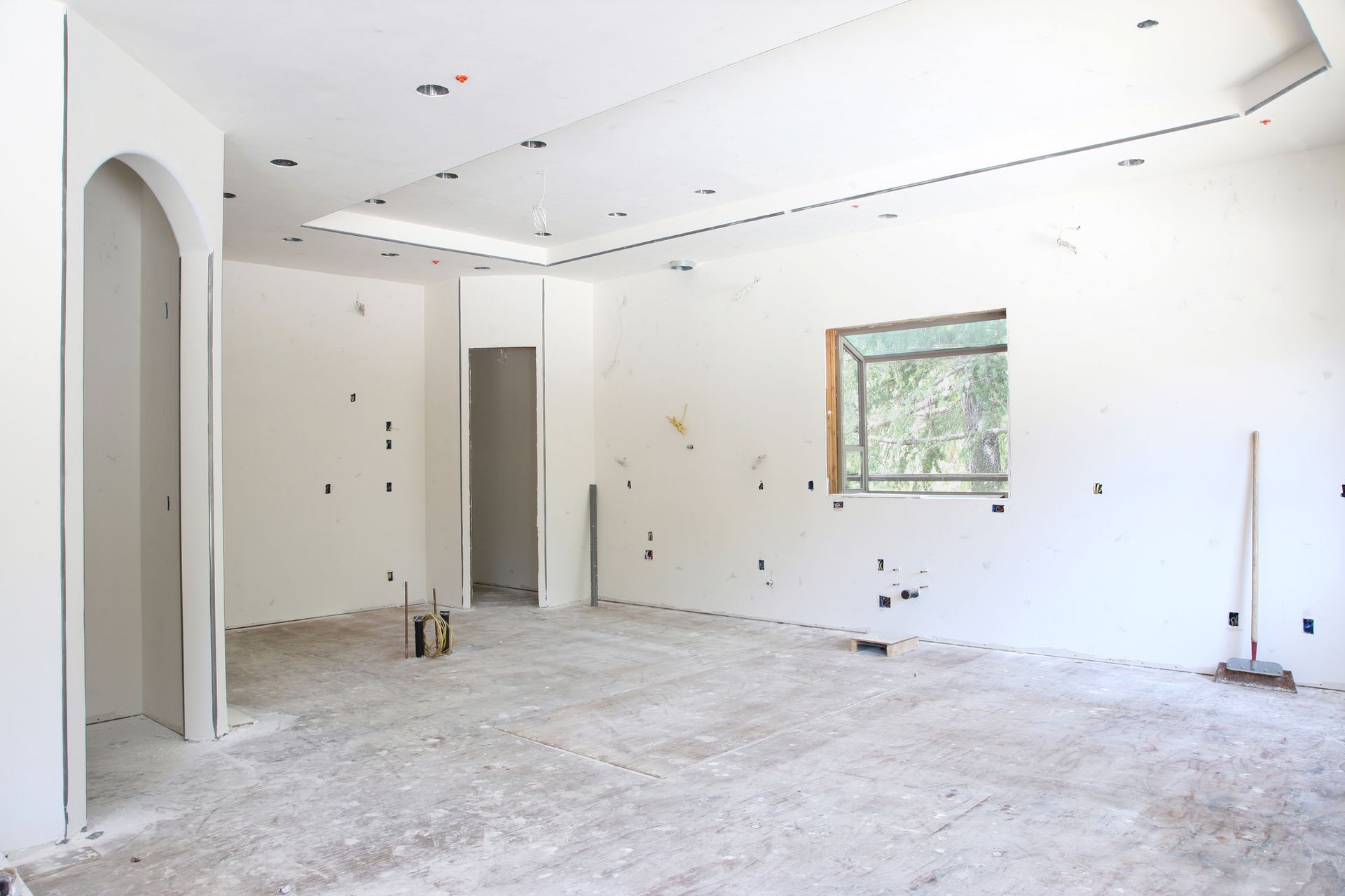 An empty room with a gray carpet and white walls.