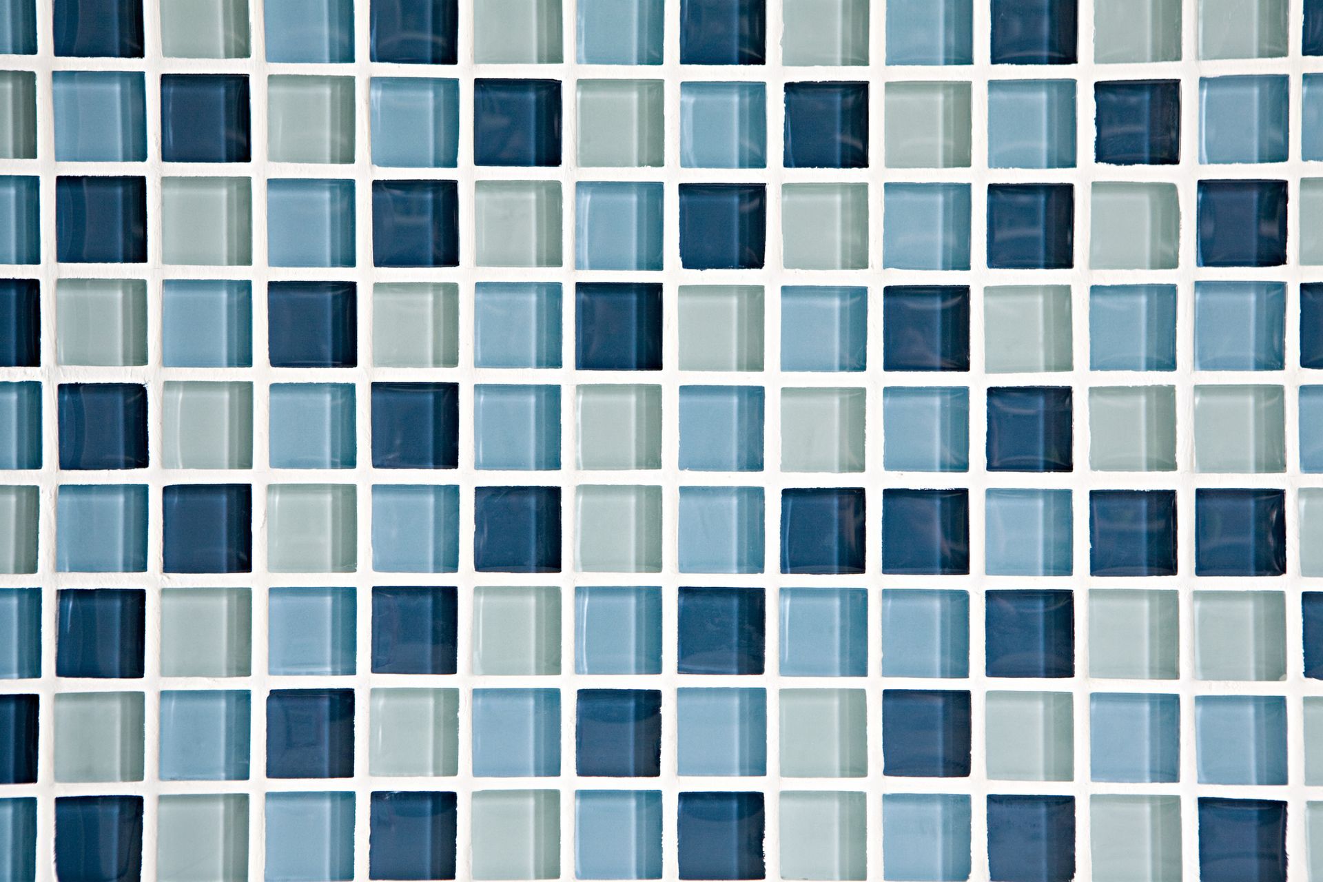 A close up of a blue and white mosaic tile wall.