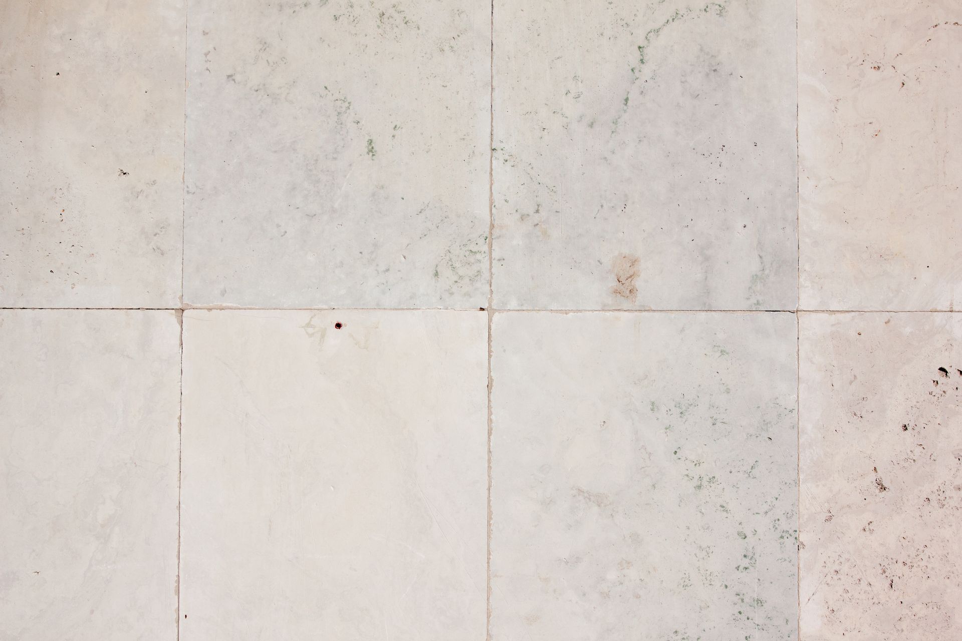A close up of a white tile floor.