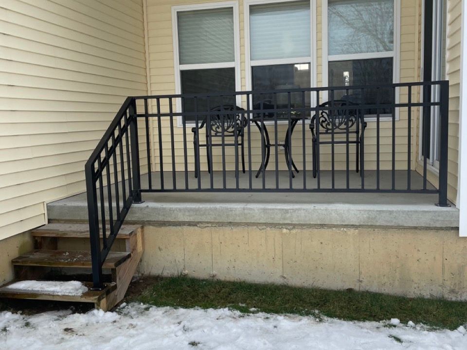 A porch with a table and chairs on it