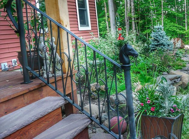 A wrought iron railing with a horse head on it