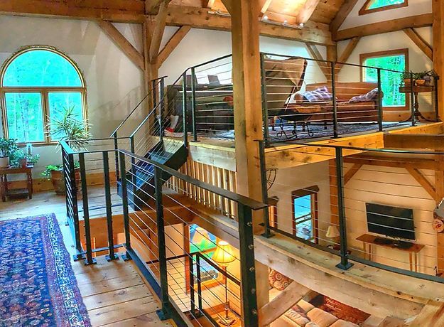 A living room with a staircase leading to the second floor.