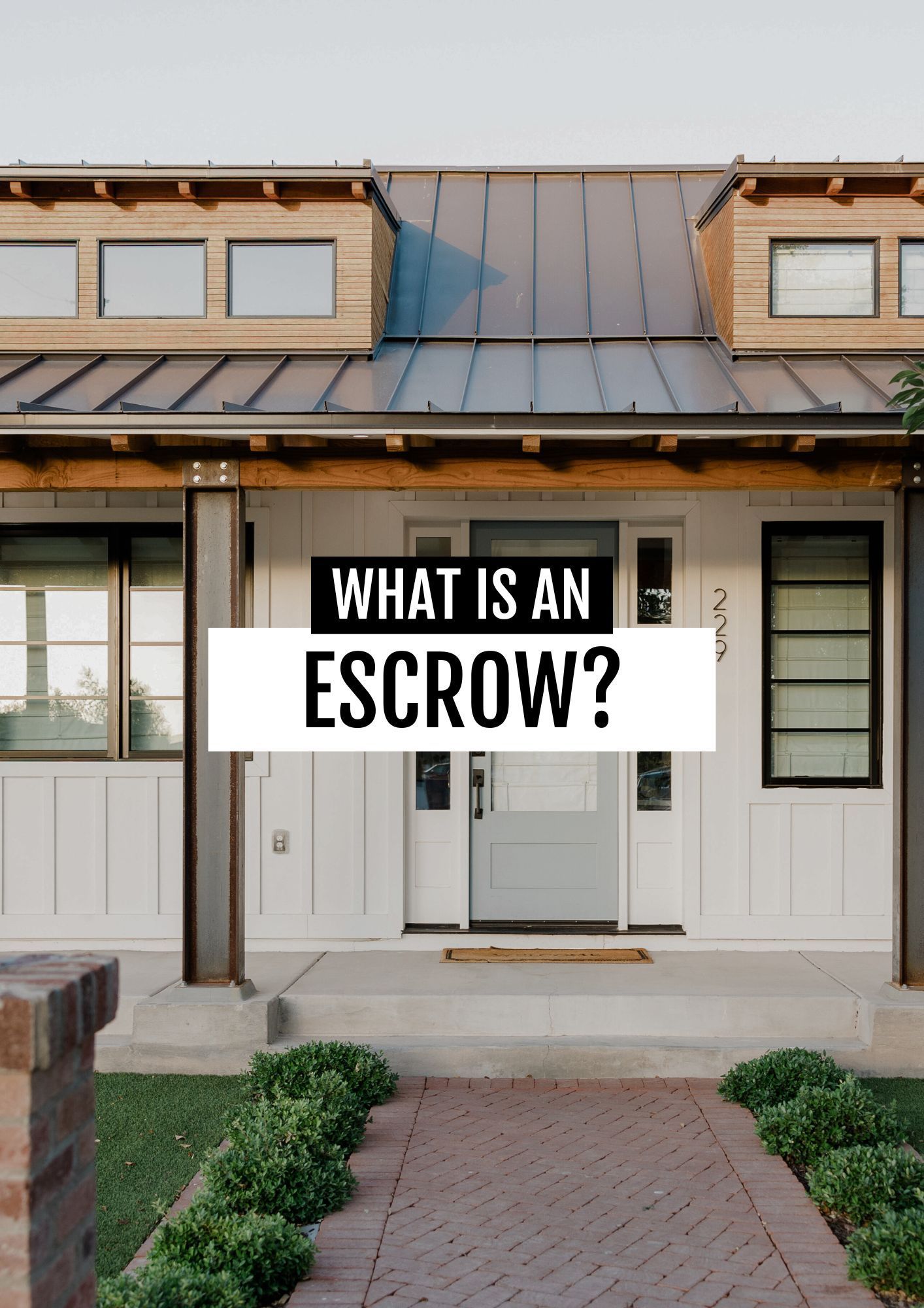 A white house with a copper roof and a sign that says what is an escrow