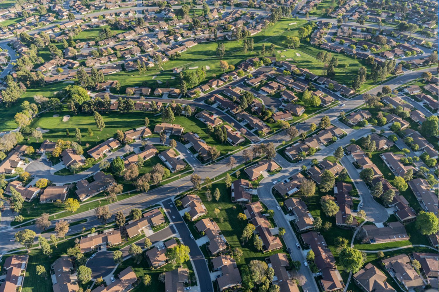 An aerial view of a residential area with lots of houses and trees.
