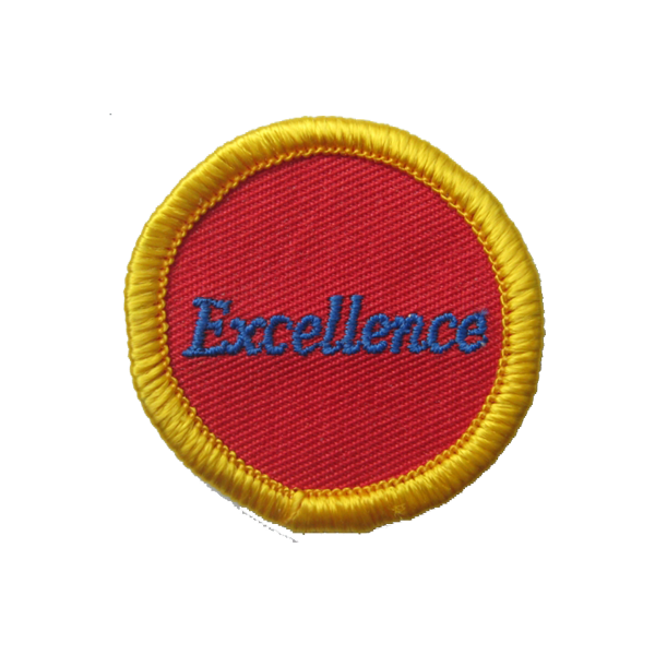 A red circle with the word excellence embroidered on it badge.