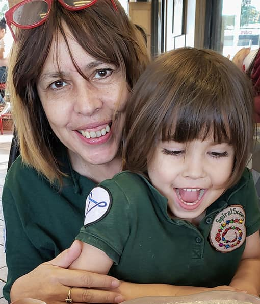 A woman is holding a little girl in her arms.