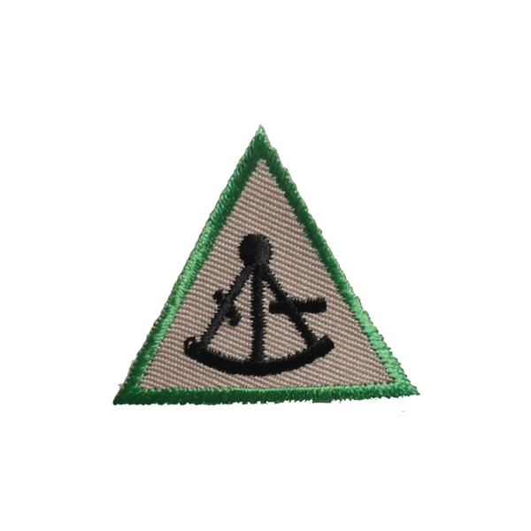 A green triangle with a black compass on it badge.