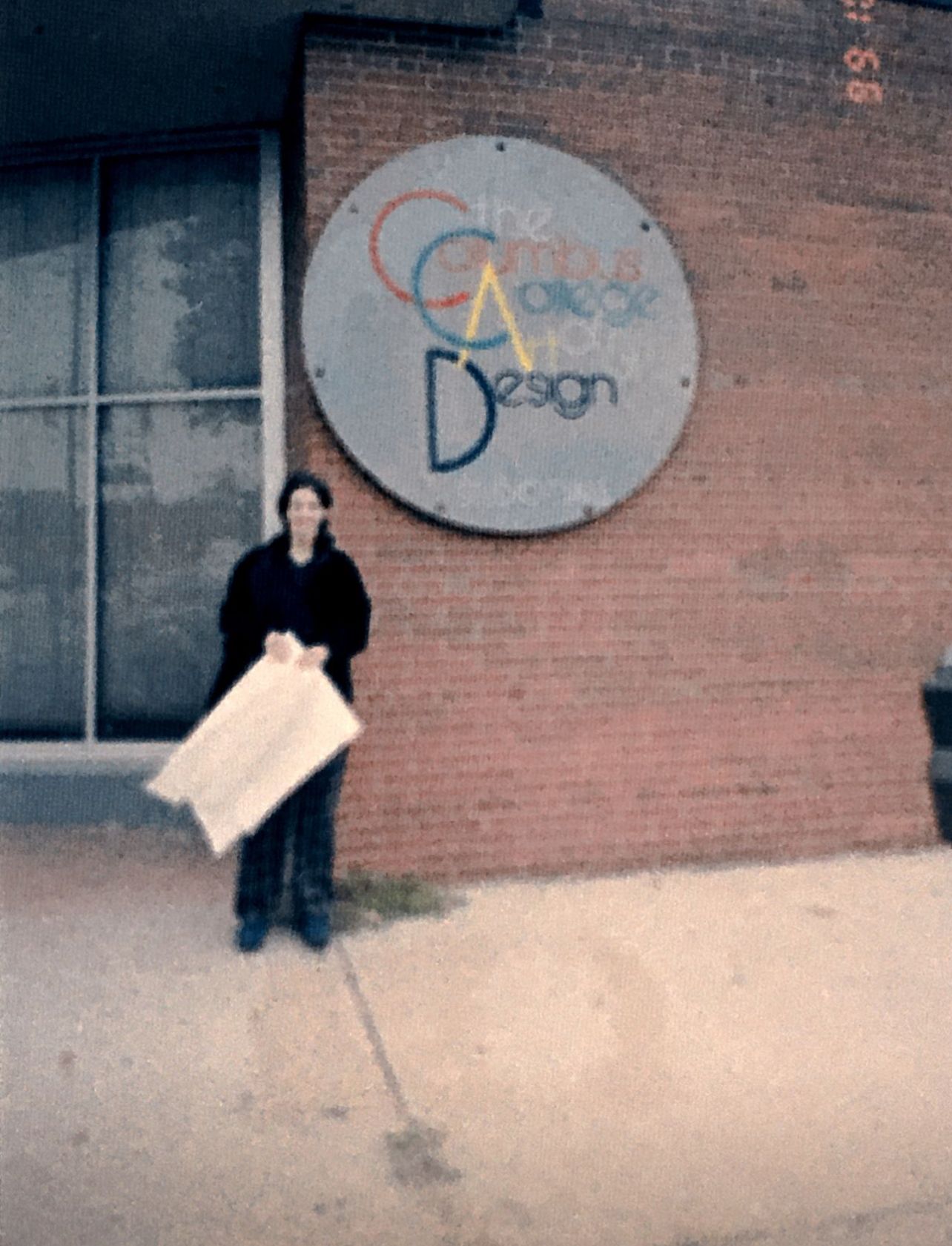 Priscila Teixeira posing in front of 122 N. Grant Ave. where she was a fashion student at CCAD in 1999
