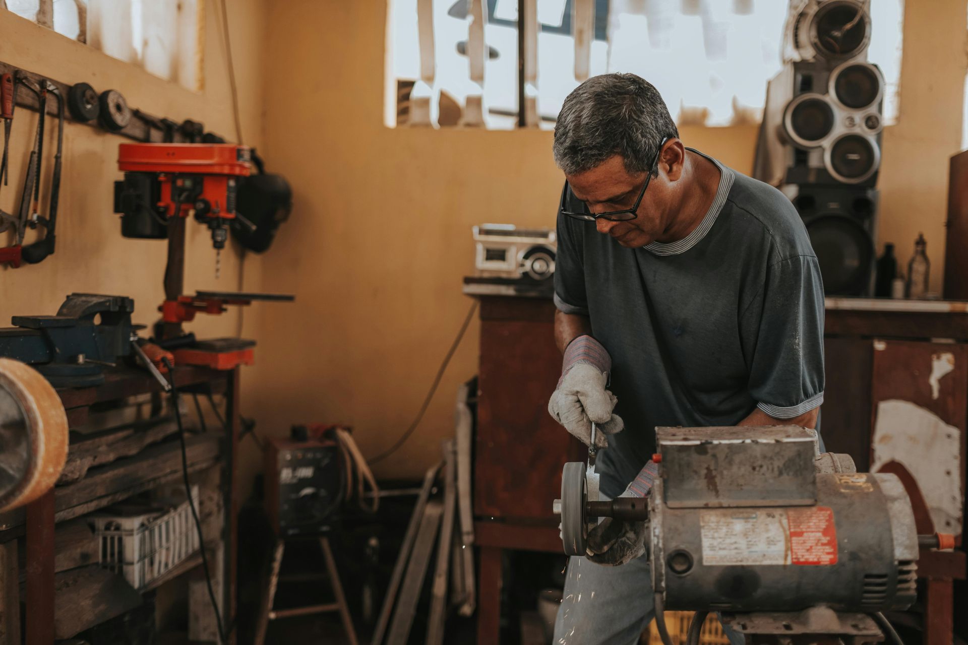 A man is working on a machine in a workshop.