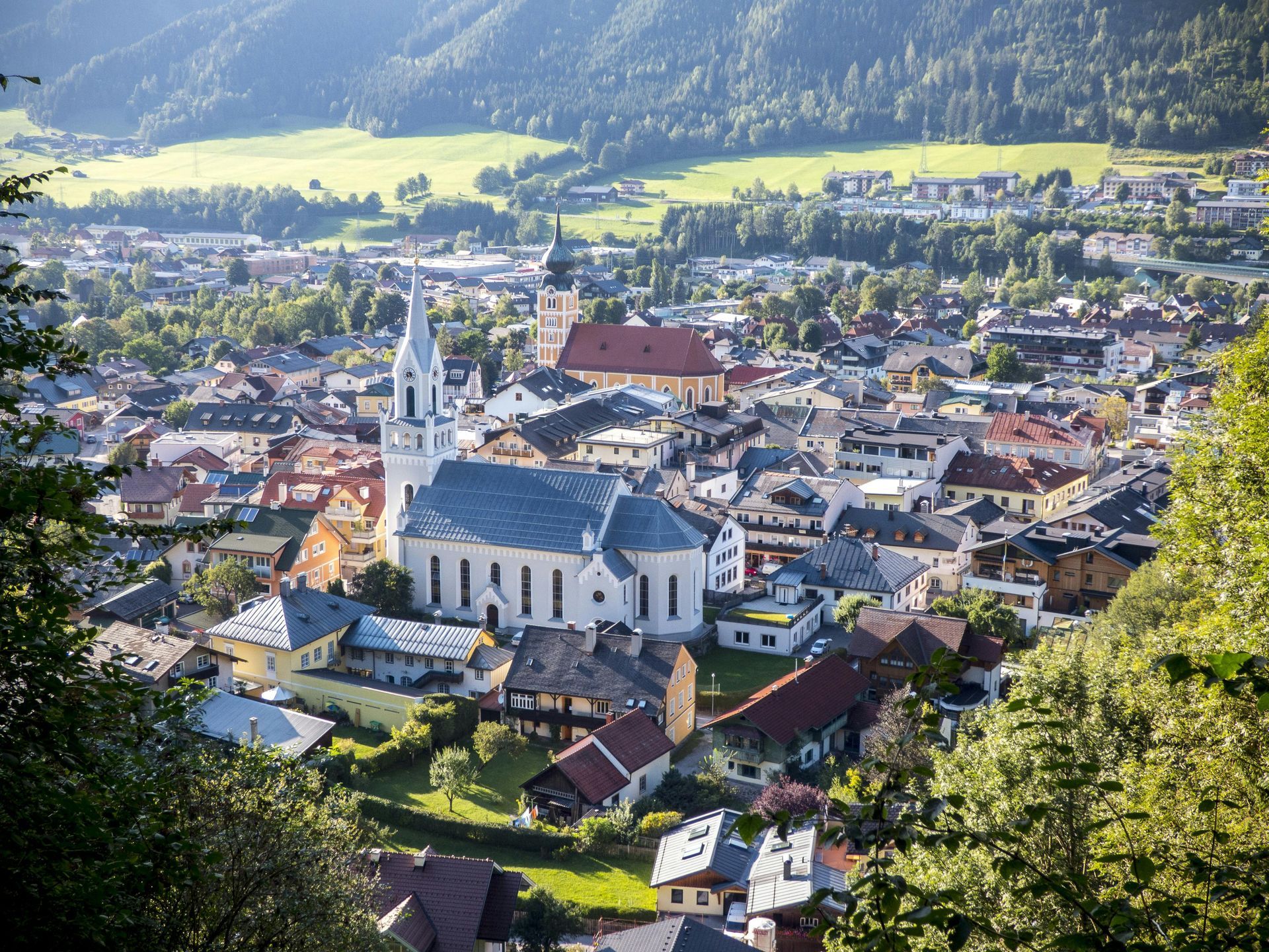 An aerial view of a small town with a church in the middle.