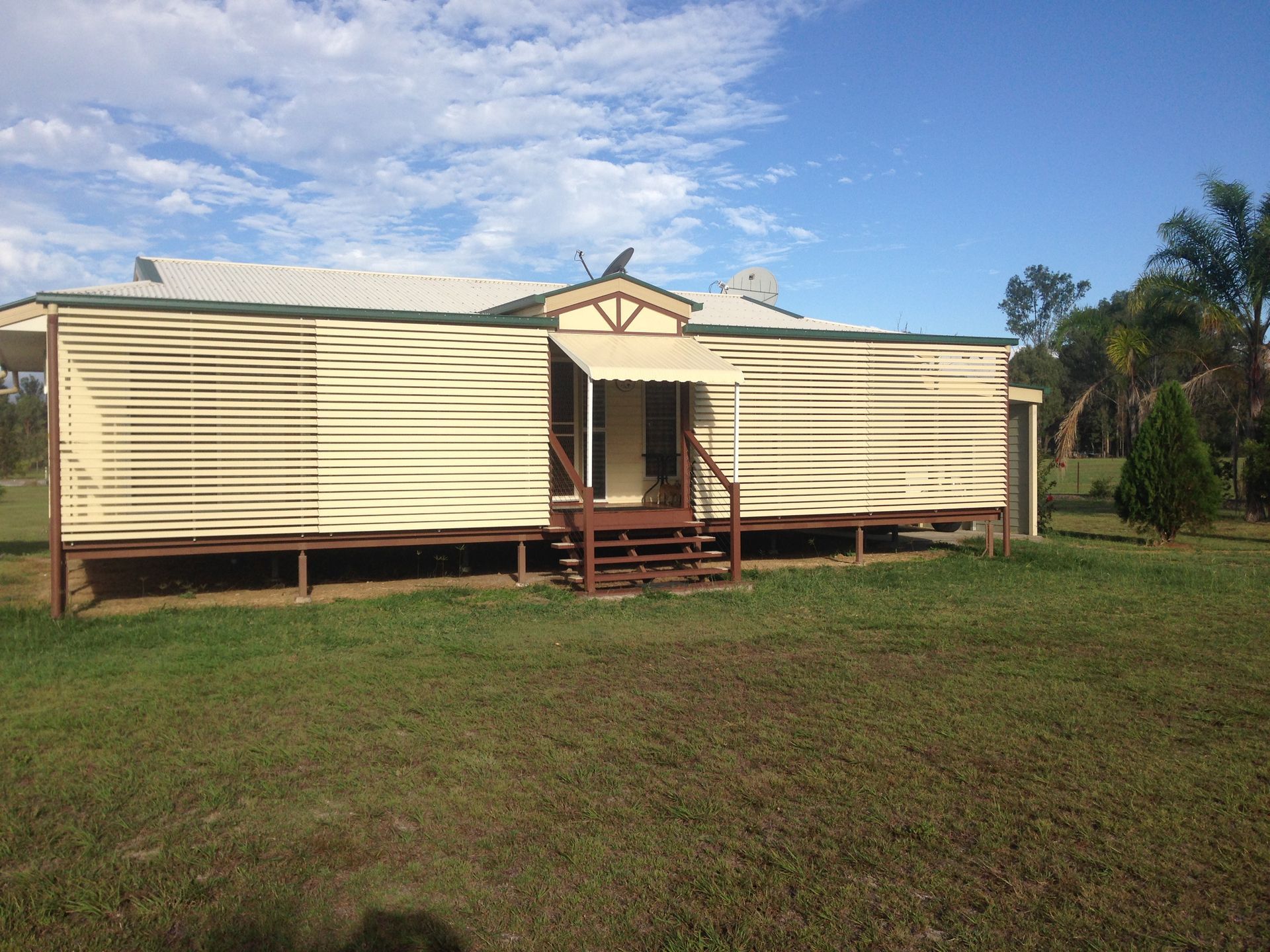 A White House With Stairs Leading To The Front Door  — Wares Blinds, Screens & Awnings In Gladstone Central, QLD